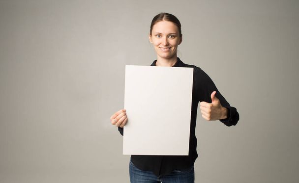 γυναίκα που κρατά ένα φύλλο χαρτί στο χέρι της - Φωτογραφία, εικόνα
