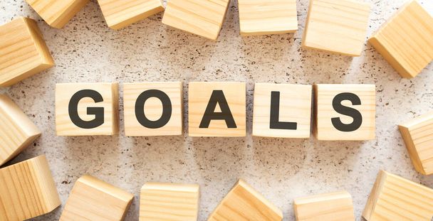 The word GOALS consists of wooden cubes with letters, top view on a light background. - Φωτογραφία, εικόνα