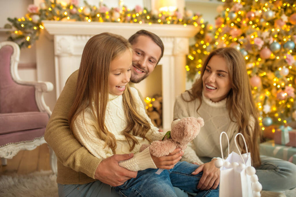 Young parents giving christmas gift to their daughter - Foto, immagini