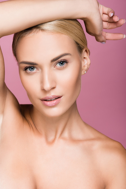 beautiful blonde woman posing with hand isolated on pink - Fotografie, Obrázek