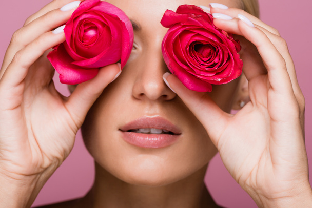 beautiful blonde woman with rose flowers on eyes isolated on pink - Φωτογραφία, εικόνα