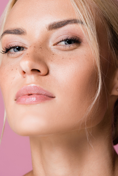 beautiful blonde woman with freckles isolated on pink - Foto, imagen
