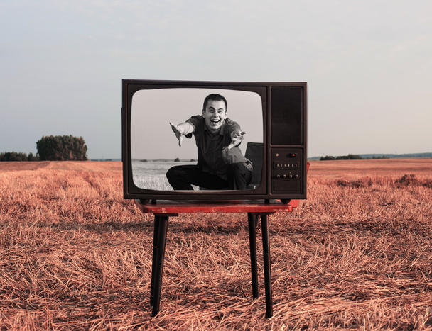 young men with TV in summer field - Foto, immagini
