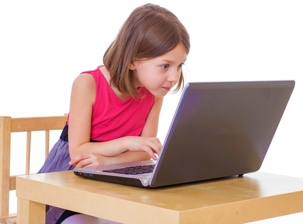  girl sitting at a laptop. - Фото, изображение