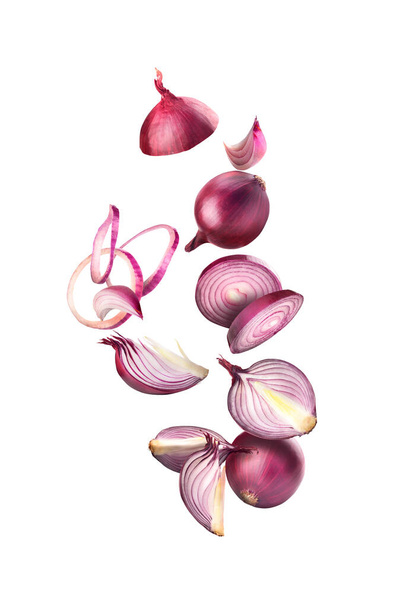 Chopped and whole onions in flight on a white background - Fotó, kép