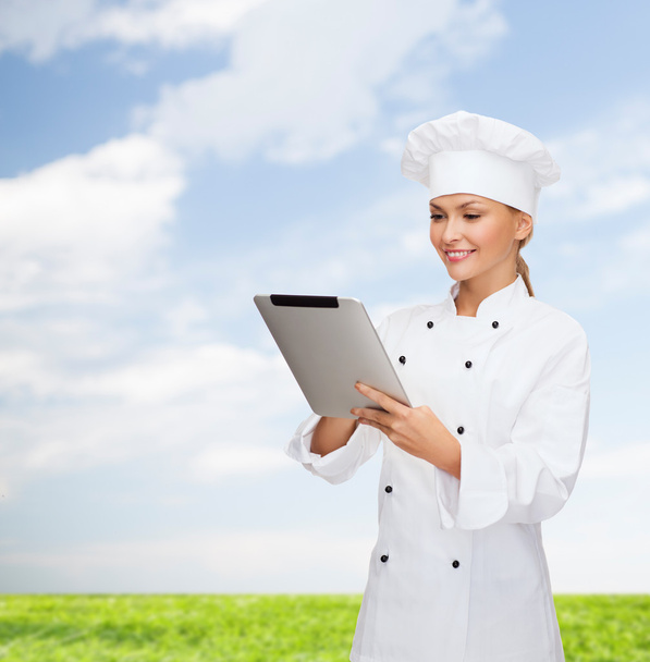 Smiling female chef with tablet pc computer - Φωτογραφία, εικόνα
