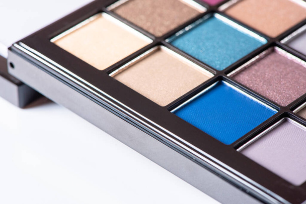 Palette of different beautiful colors of eye shadow close-up. Macro photography of makeup cosmetics - Photo, Image