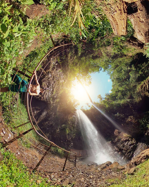 Man black in green eco park waterfall with 360 camera. Man on mini green planet. - Photo, Image