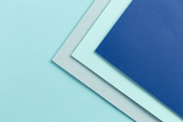 Material design blue background. Craft paper sheets are folded in different ways. A photo - Valokuva, kuva