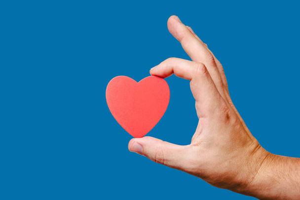 heart in hand on blue background - Фото, зображення