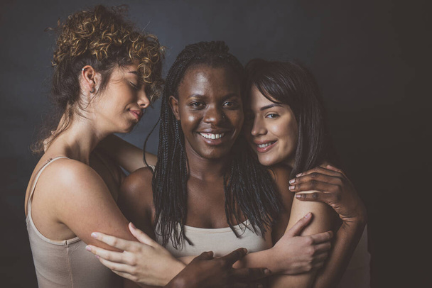 Three girls from different ethnicities posing in studio for a "body positivity" photo session - Photo, image