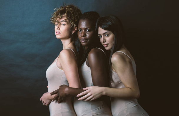 Three girls from different ethnicities posing in studio for a "body positivity" photo session - Photo, image