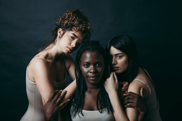 Three girls from different ethnicities posing in studio for a "body positivity" photo session - Fotó, kép
