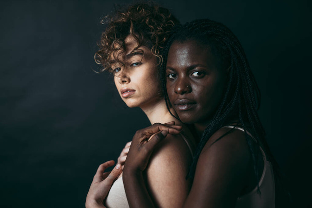 Two girls from different ethnicities posing in studio for a "body positivity" photo session - Photo, image