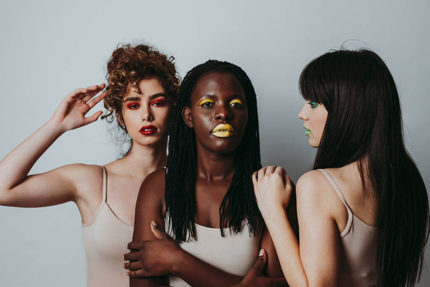 Three girls from different ethnicities posing in studio for a "body positivity" photo session - Zdjęcie, obraz