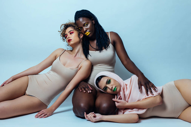 Three girls from different ethnicities posing in studio for a "body positivity" photo session - Foto, Bild