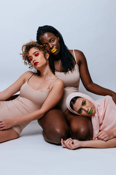 Three girls from different ethnicities posing in studio for a "body positivity" photo session - Photo, Image