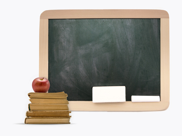 Empty blackboard with wooden frame, old books and apple - Photo, Image