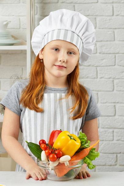 little child girl holding bowl of fresh vegetables - Fotoğraf, Görsel