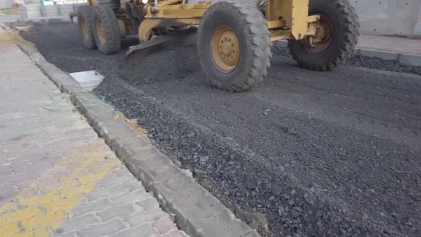 Road repair work. excavator metal bucket digs ground before laying asphalt. - Footage, Video