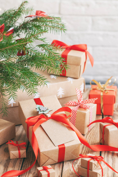 Many Handmade zero waste Christmas gift boxes under fir tree on floor in room. - Foto, Imagen