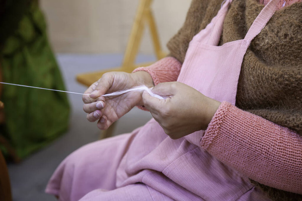 Spinner working in sewing with wool, artisan production, industry - 写真・画像