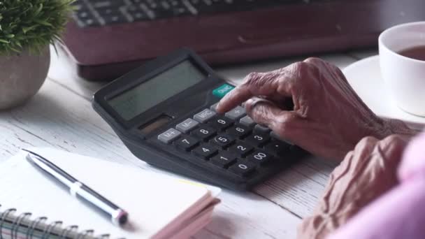 mano de las mujeres mayores usando calculadora en el escritorio  - Imágenes, Vídeo