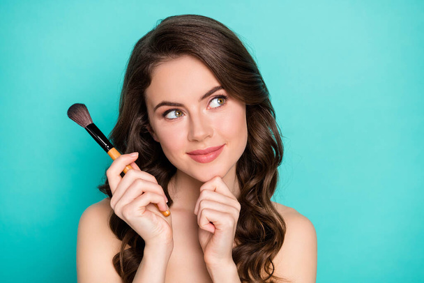 Closeup photo of beautiful naked lady wavy long hairdo hold professional makeup brush think over evening date visage style look side creative isolated teal color background - Fotoğraf, Görsel