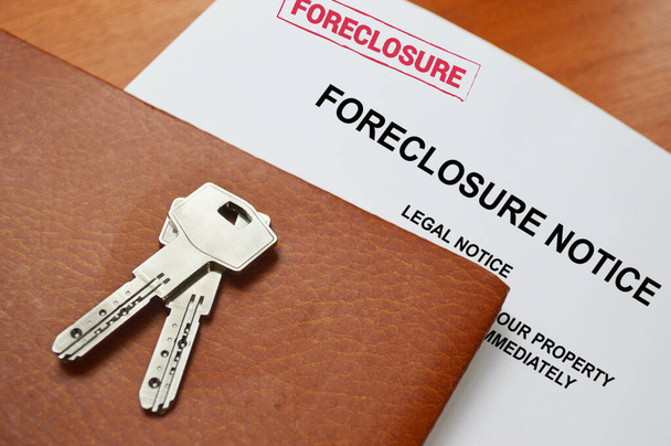 A foreclosure Notice And House Keys on a table with space for text - Foto, Imagen