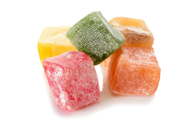 Turkish delight. Different types of rahat locum. Five colorful pieces of sweet oriental delights in powered sugar, close-up view. - Foto, imagen
