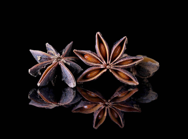 still life with star anise over black reflective tablet - Фото, зображення