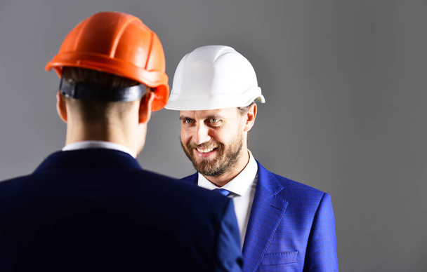 Entrepreneur and architect wearing helmets. Career, business, building, success concept. - Photo, Image