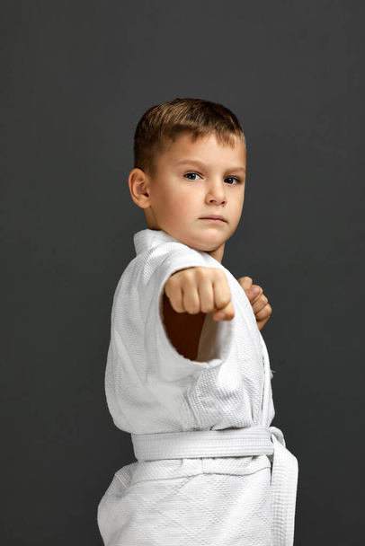 boy dressed in a white karate kimono - Φωτογραφία, εικόνα