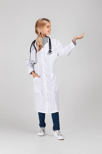 Cute child in doctor coat with stethoscope - Photo, image