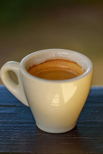 Witte beker met koffie. witte koffiekop op achtergrond. Espresso koffie ochtend vrolijkheid - Foto, afbeelding
