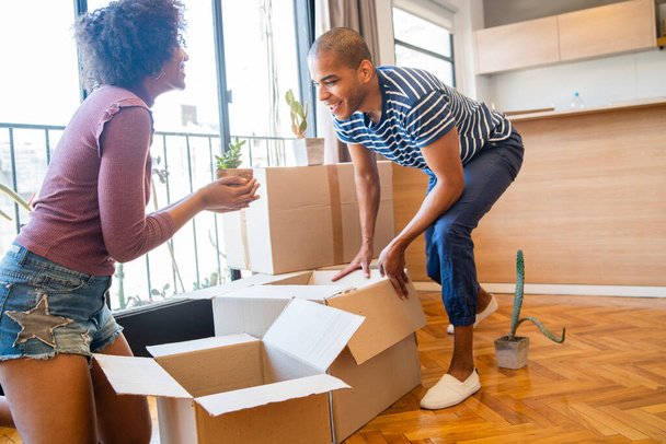 Couple packing cardboard box to move in new apartment. - Photo, image