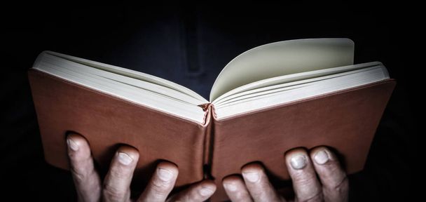 Open book in man hands. - Фото, изображение