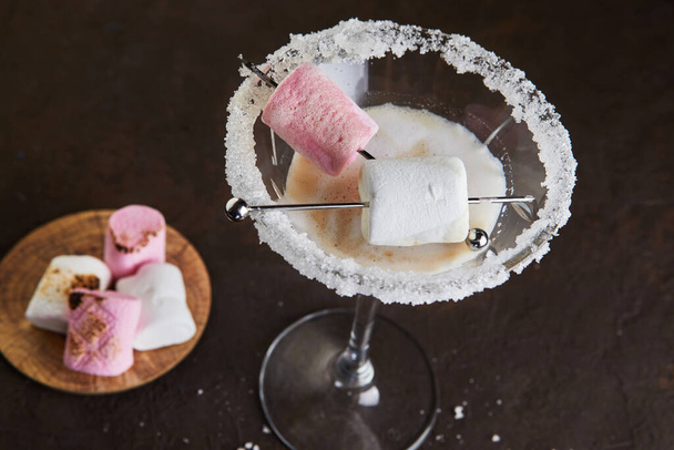 Irish cream liqueur in a martini glass with marshmallows. Close up - Photo, Image