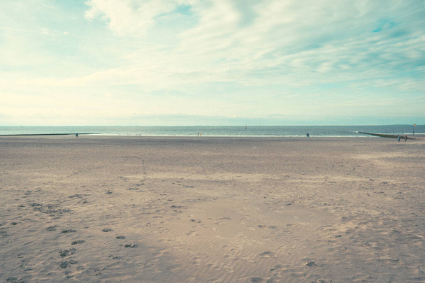 A beautiful view of a beach under breathtaking clouds in Borkum, Germany - Foto, imagen