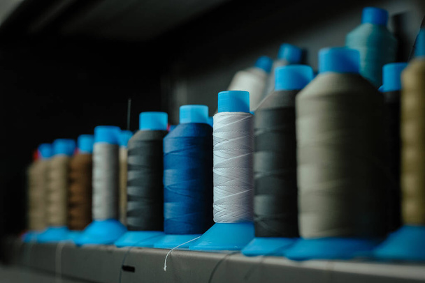 A selective focus shot of sewing threads in an atelier - Zdjęcie, obraz