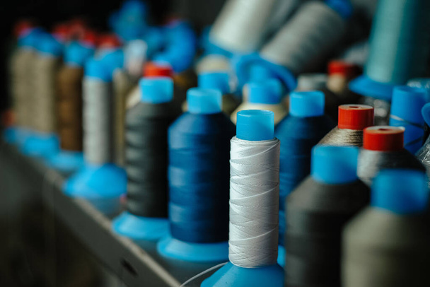 A selective focus shot of sewing threads in an atelier - 写真・画像