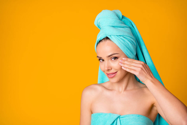 Portrait of positive attractive person arm touch face turquoise towel isolated on vibrant yellow color background - Фото, зображення