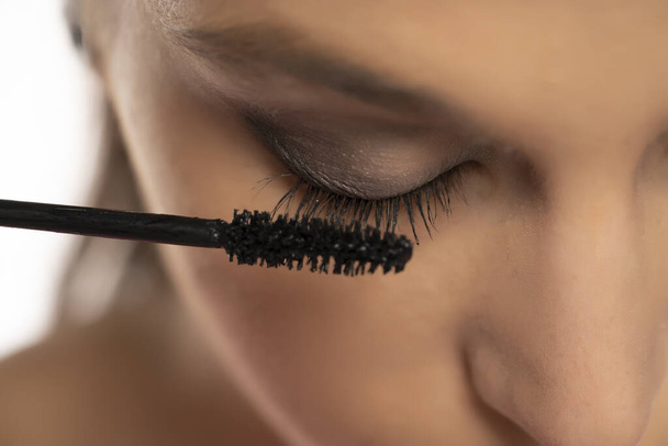 Closeup of mascara applying on female natural eyelashes - Fotografie, Obrázek