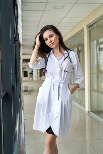 Portrait of young girl student at a medical institute with stethoscope. Advertising space - Foto, afbeelding