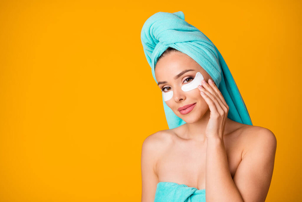 Portrait of gorgeous lady arm touch under eye pad cute face teal towel isolated on yellow color background - Fotoğraf, Görsel