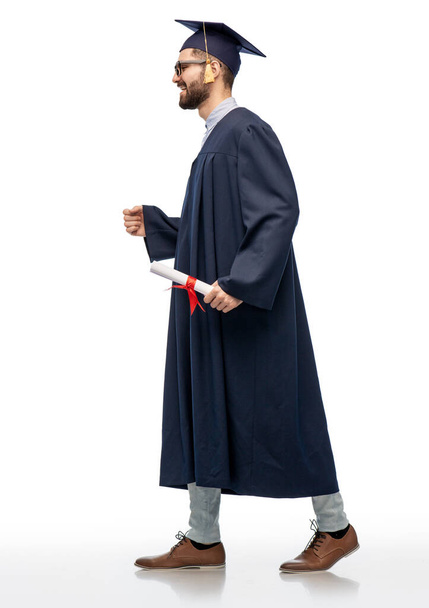 male graduate student in mortar board with diploma - 写真・画像