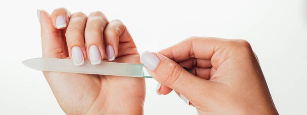 Hand filing nails with glass nail file on  background - Photo, Image