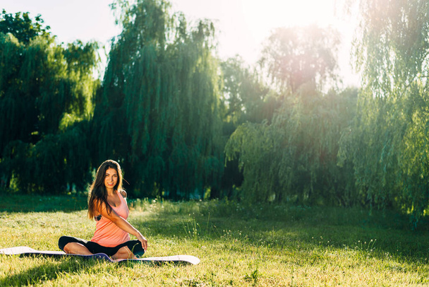 young attractive woman doing yoga in the park, active lifestyle - Fotó, kép