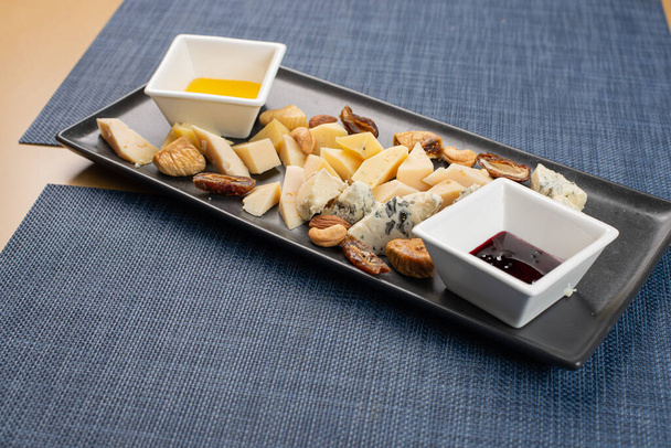 Cheese plate served nuts and honey - Photo, Image