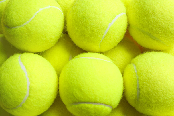 Tennis balls as background, closeup. Sports equipment - Photo, image